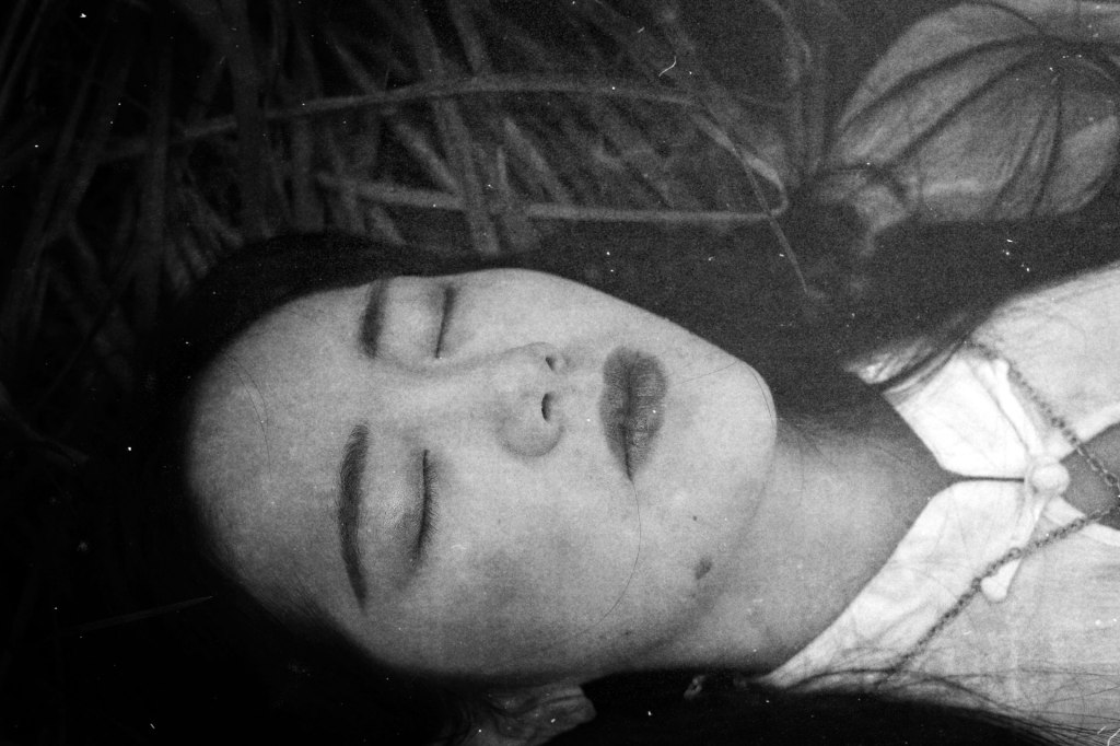 girl-portrait-on-grass-dark-monochrome
